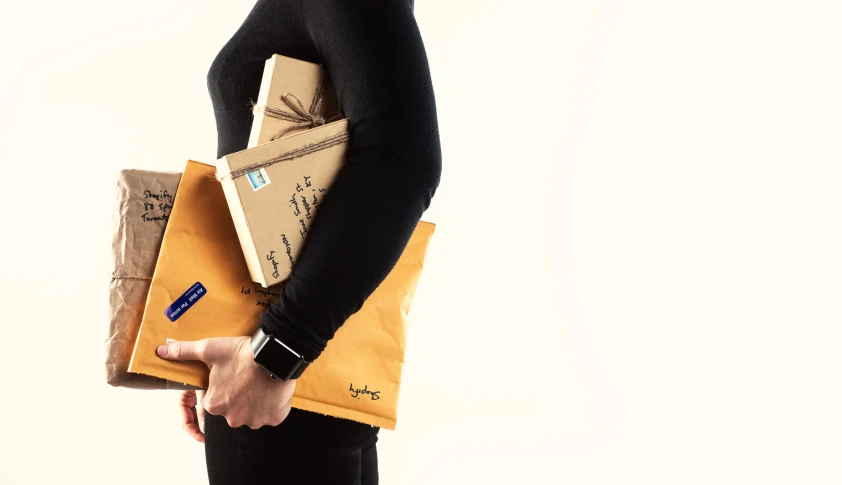 woman holding several folders in both hands