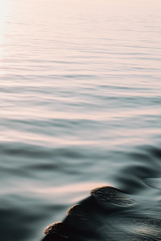 there is a person riding on the waves in the ocean