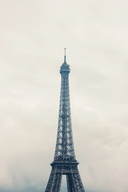 an eiffel tower towering above a parking lot