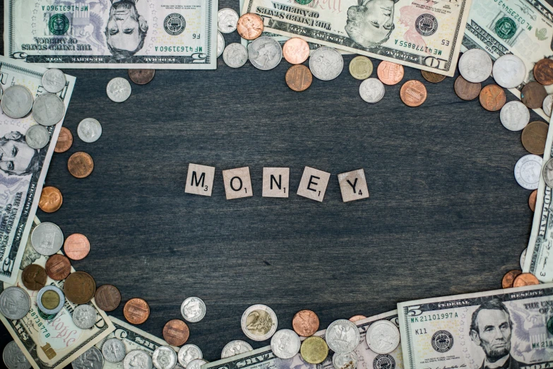 money and words spelled out on top of a table