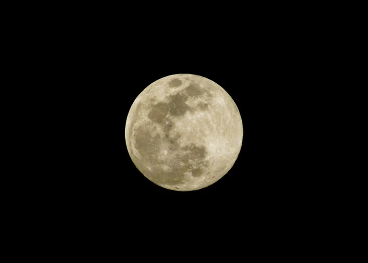 a plane is flying through the sky, and there's a full moon in the background