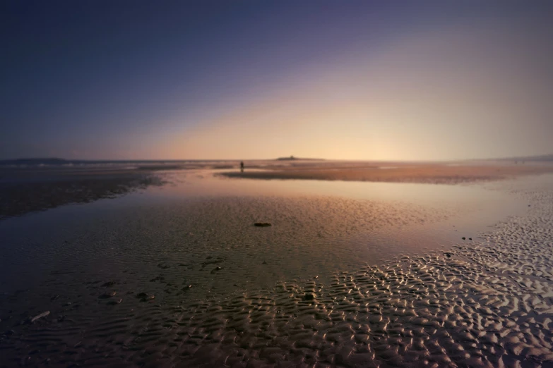 a beach in the morning has some water and sand