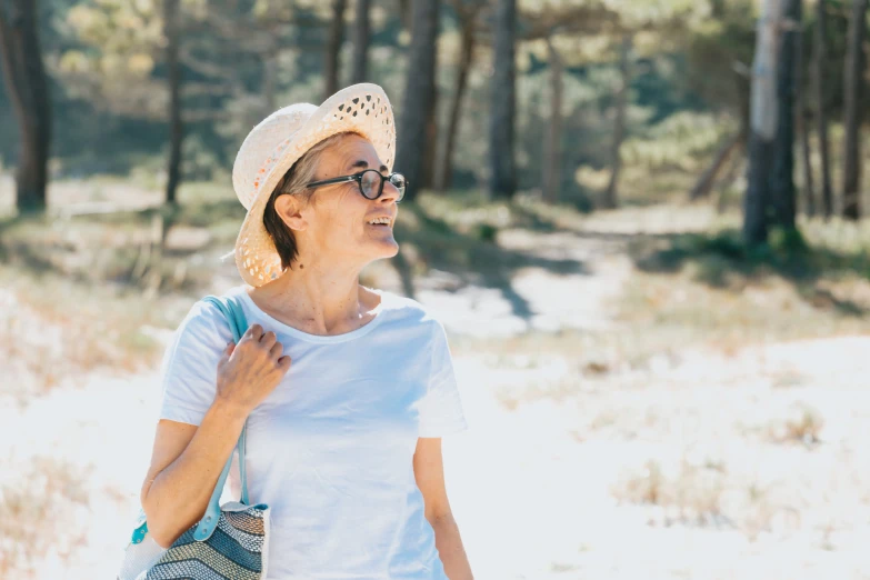 a woman walking on a trail in the forest