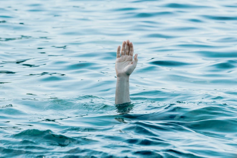 a hand that is out in the water