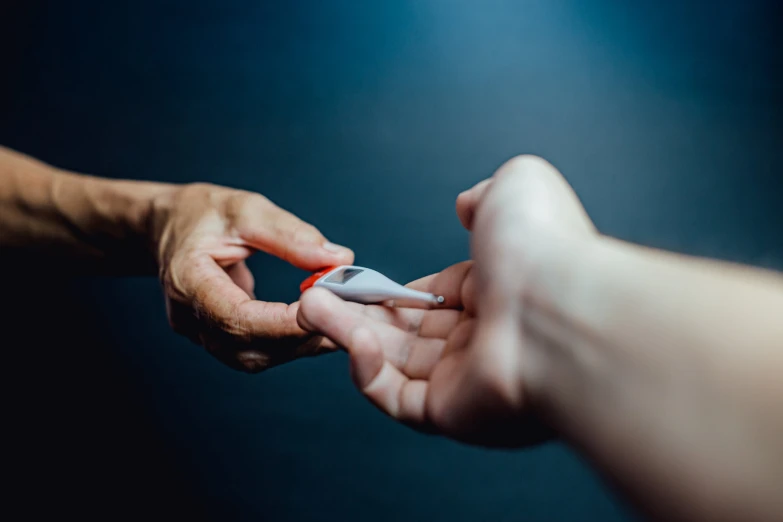 two people touching hands with a toothbrush