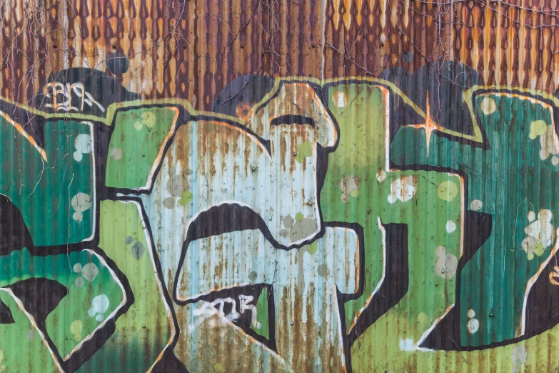 graffiti on a wooden surface with an orange fence