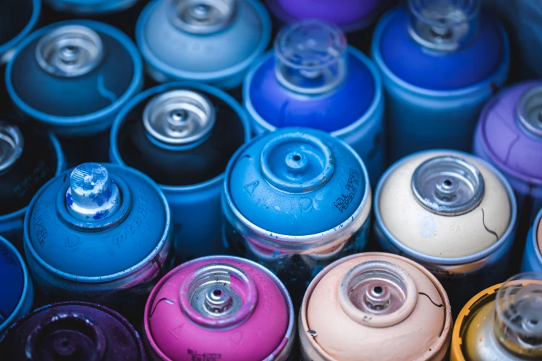 many cans are sitting together in a blue bucket