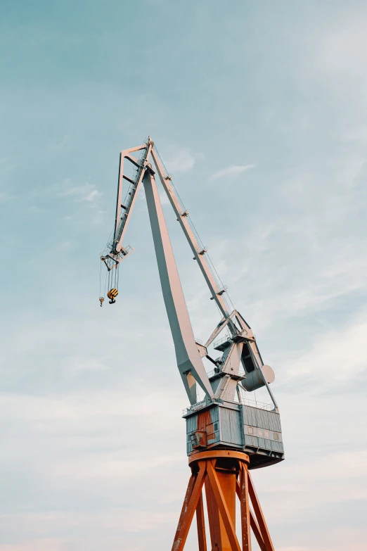 the wooden tower is attached to the large crane