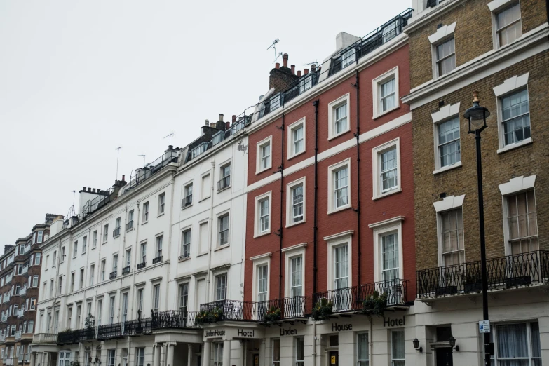 a row of multi - storyed houses with a street lamp next to them