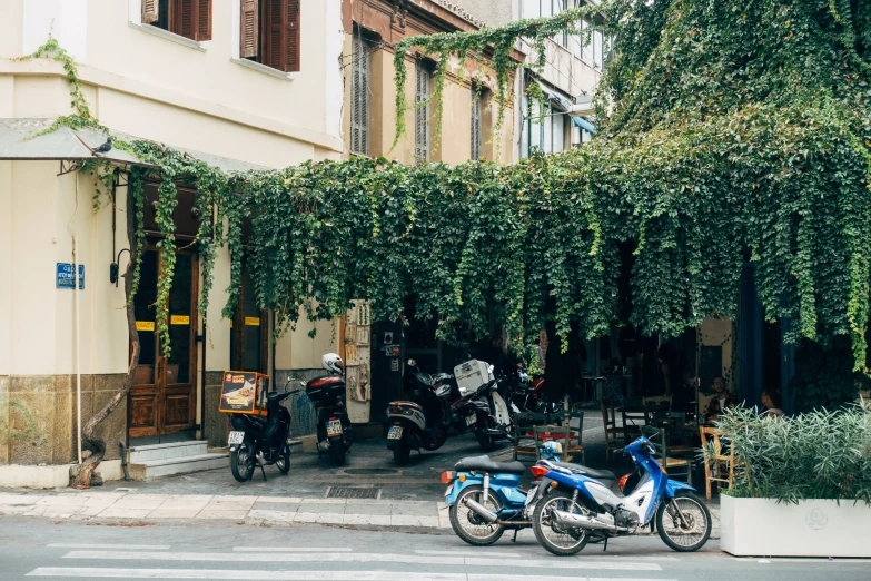 motorcycles parked in front of an apartment building