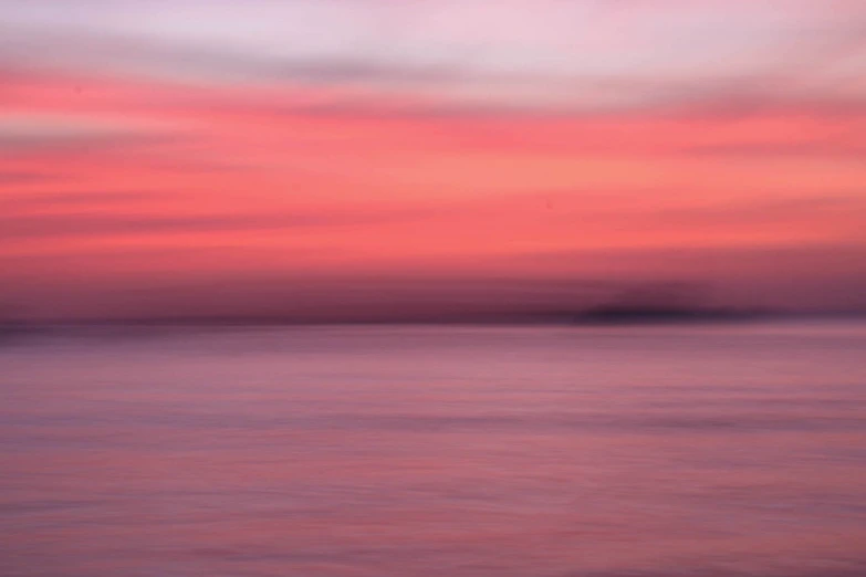 pink sky with clouds over a lake during sunset