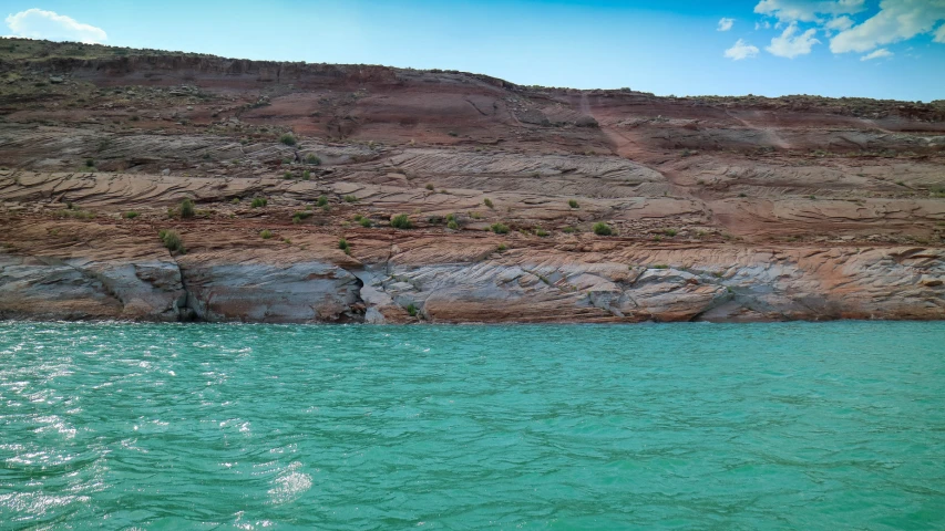 the water is so green it looks like it could float on the surface of the rock