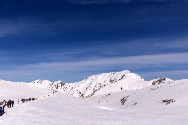 people on skis standing on a mountain covered with snow