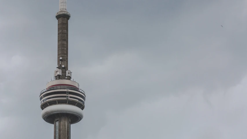 there is an airplane in front of the very tall tower