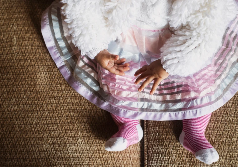 the baby is sleeping in her blanket on the bed