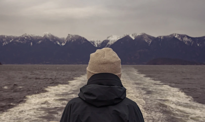 a person looking out to the sea from a boat