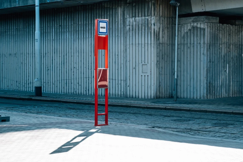 a red pole next to a parking garage