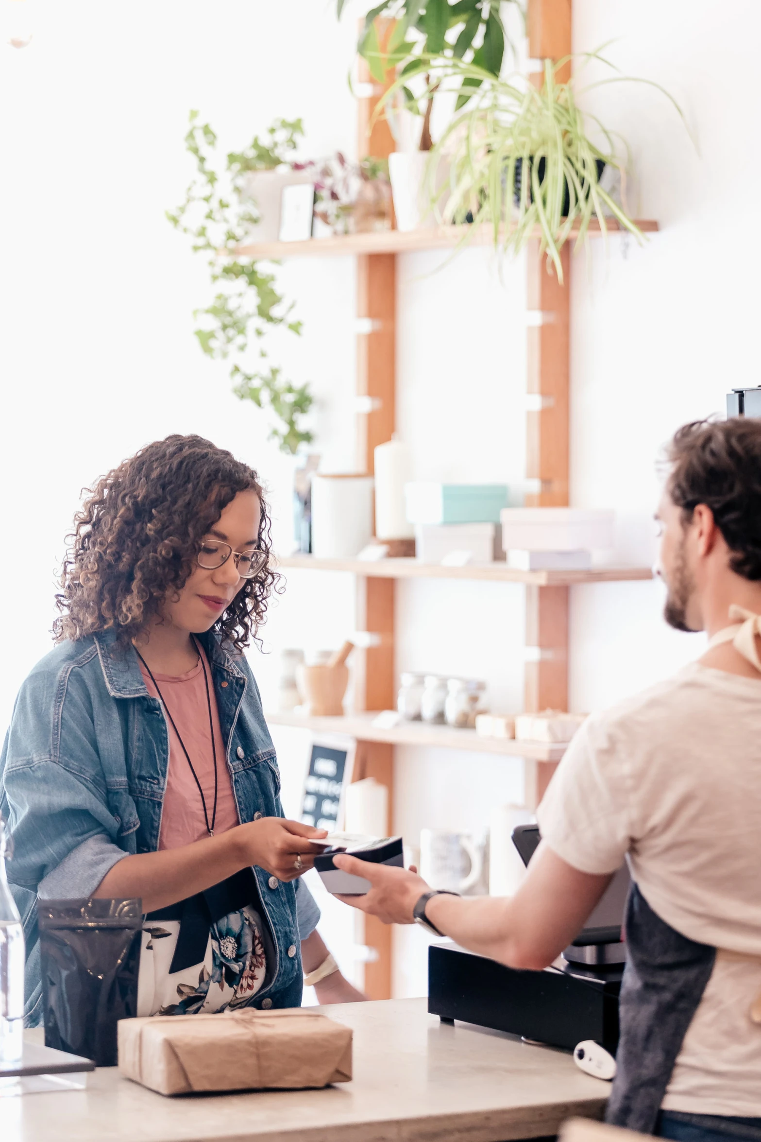 woman paying a man at a shop