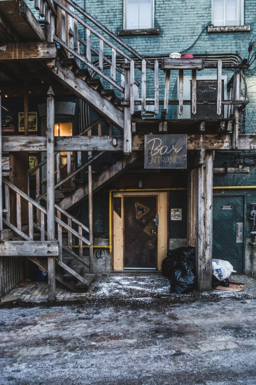 an abandoned building that has been boarded down with graffiti and trash