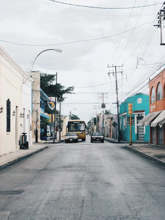 the yellow truck is going down the deserted street