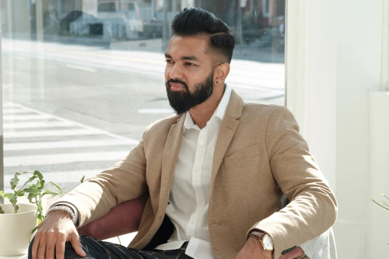 a man with a beard sitting at a table