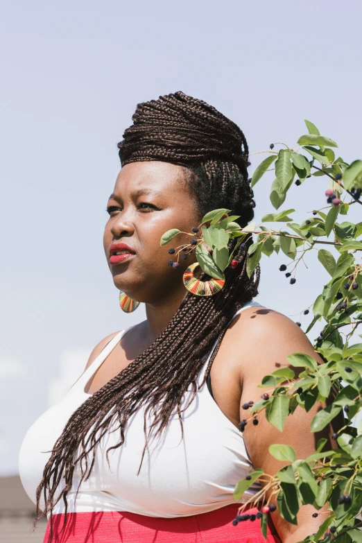 an african american woman is posing with her long black hair in the wind