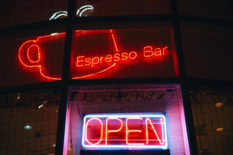 a neon lit business sign with the words open on it