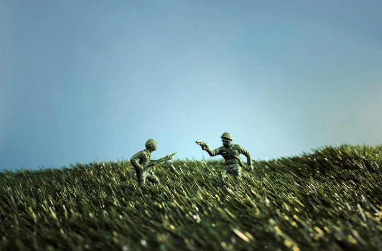 two figures standing in grass that are facing each other