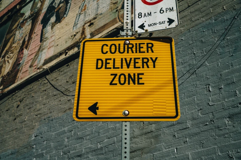a yellow sign that reads courier delivery zone