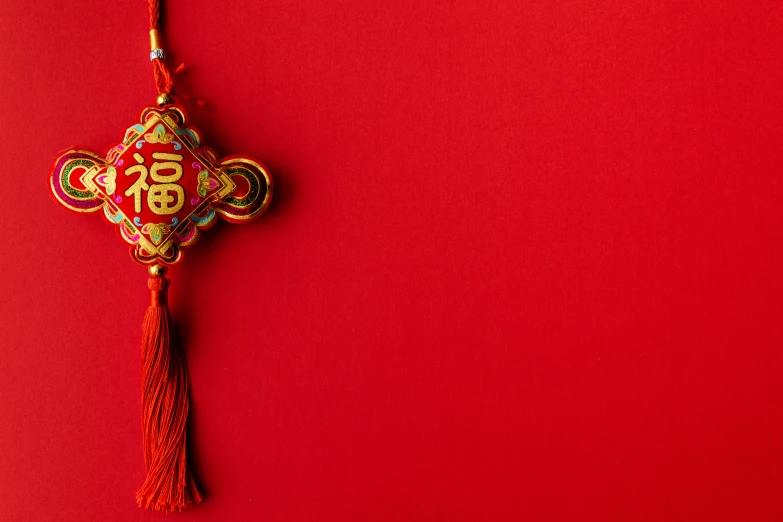 red and gold chinese key hanging on a string