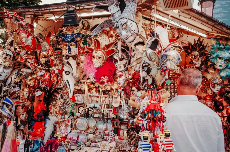 an assortment of masks on a street market stall