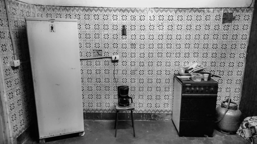 an old fashioned refrigerator and a old stove in a home kitchen