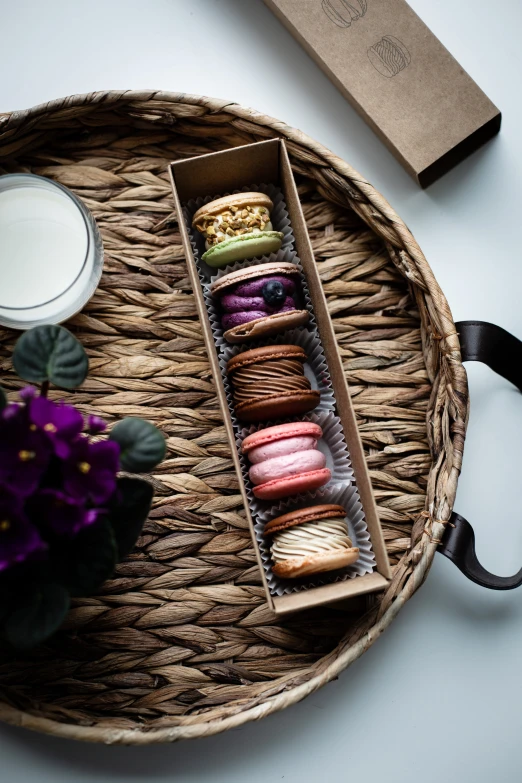 a wicker tray holding several different types of donuts