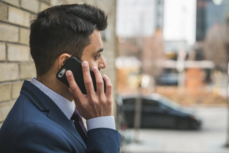 the young man is talking on the phone