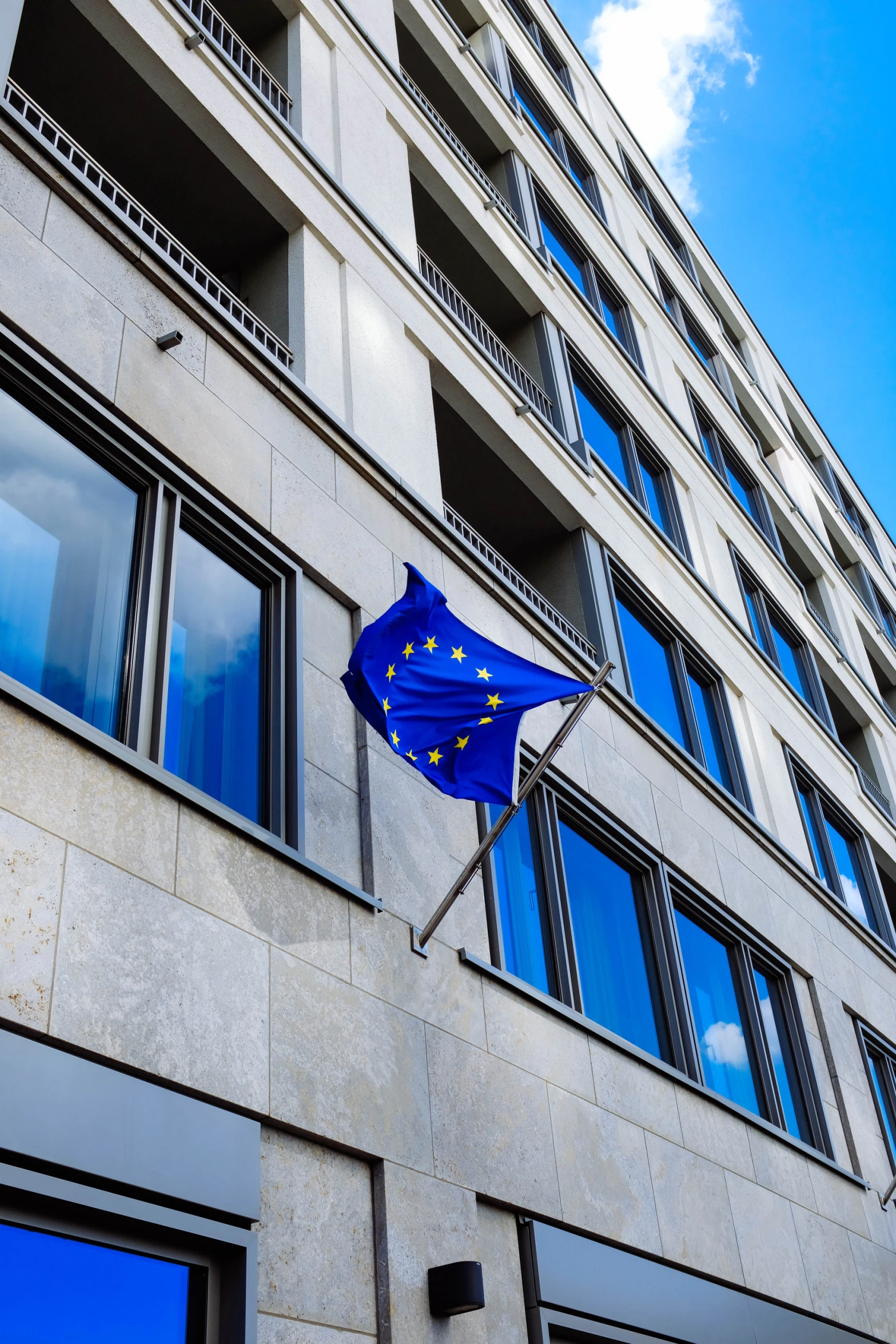 european flag flying in front of large building