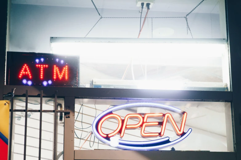 the open sign is lit up with blue and red lighting