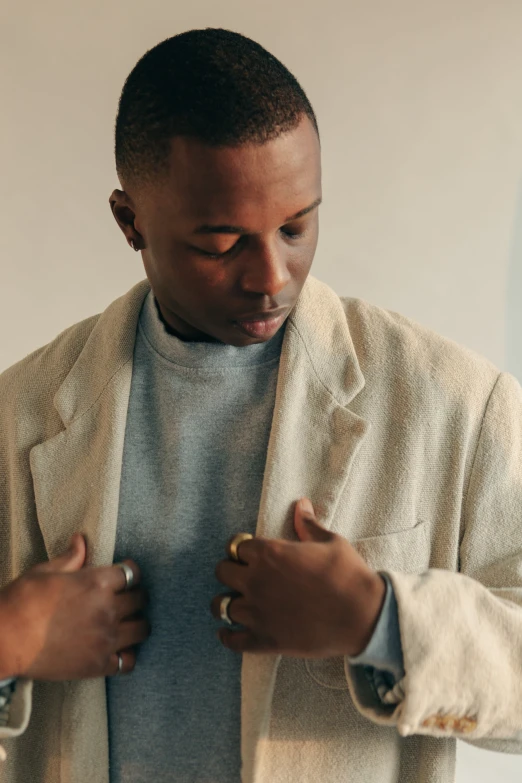 a man wearing a tan cardigan sweater