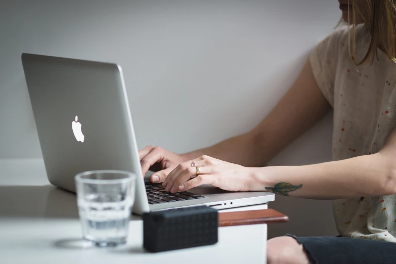 there is a woman sitting in front of her laptop