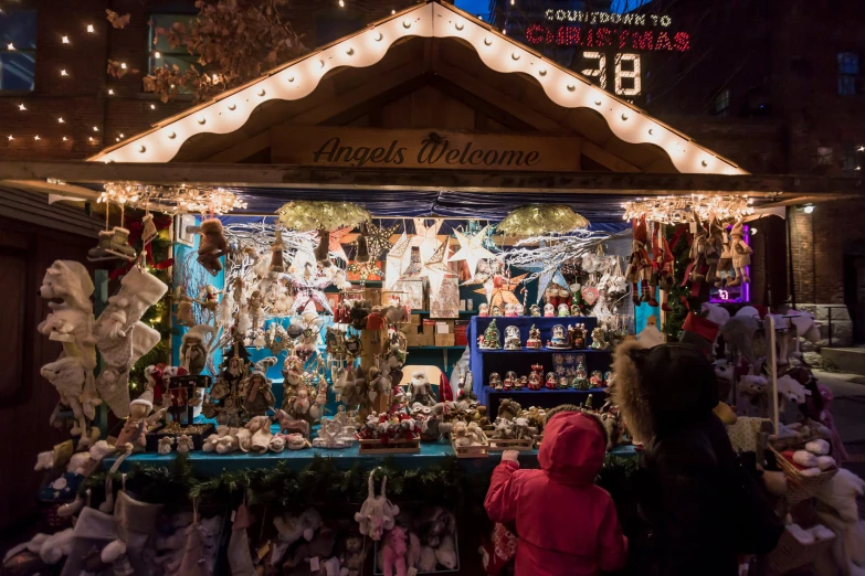 a market with christmas decorations and lights at night