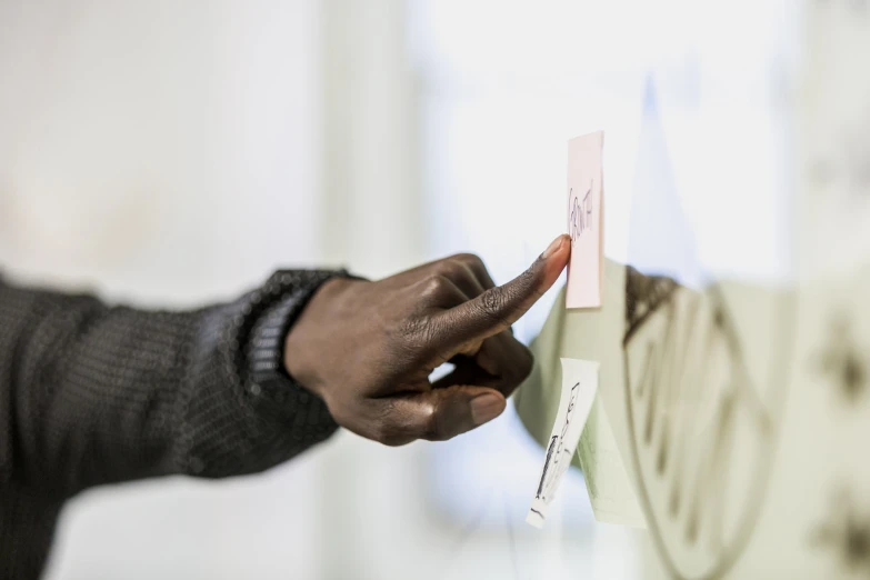 man opening up a clock to put his hand on the post - it