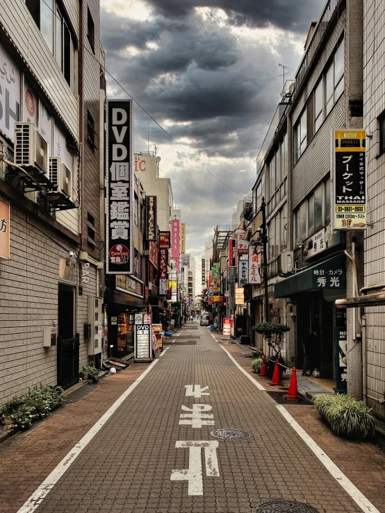 this is an empty city street with buildings and signs