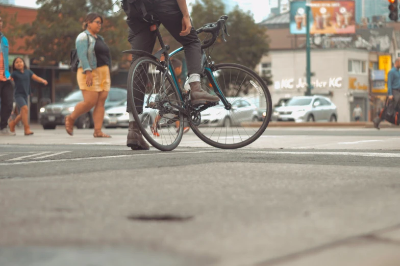 a man with backpack riding a bike in the city