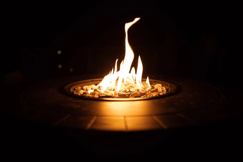 the bonfire is glowing in the dark on a patio