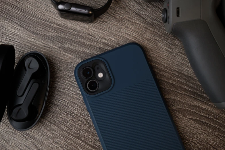 a dark blue cellphone laying on a wood table