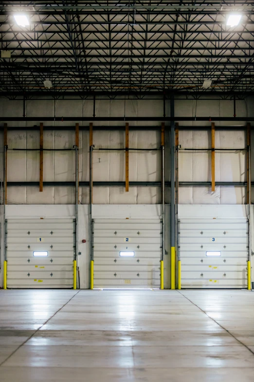 there is an empty warehouse with white doors