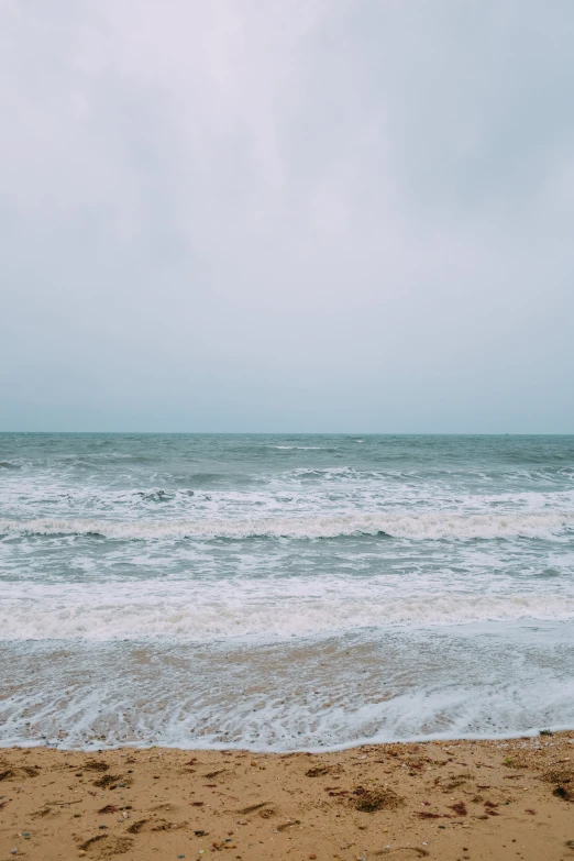 people standing in the surf at the beach