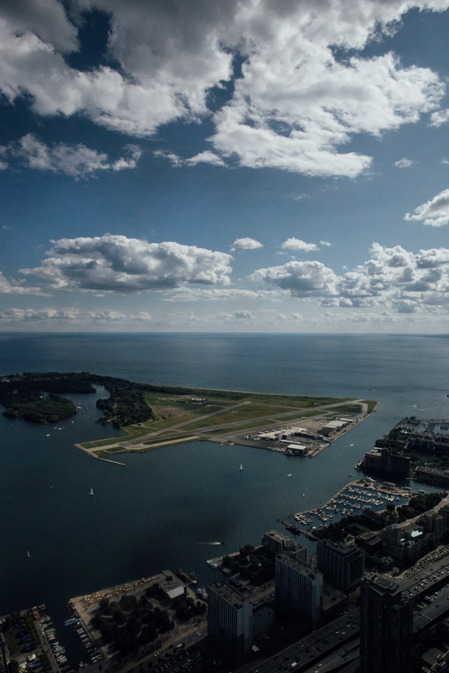 a city sitting on the edge of a body of water under a cloudy sky