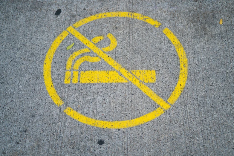 a no smoking sign drawn on the ground