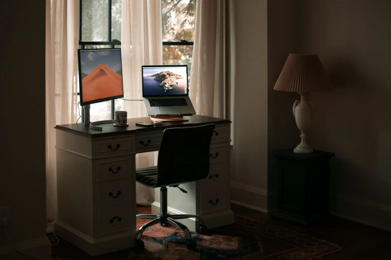 the desk has a laptop and monitor on it