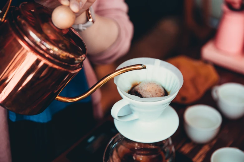 a coffee maker is being filled with a mixture of coffee, including sugar,